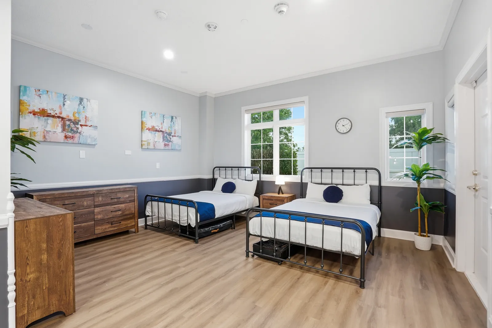 Two beds, dresser and artwork